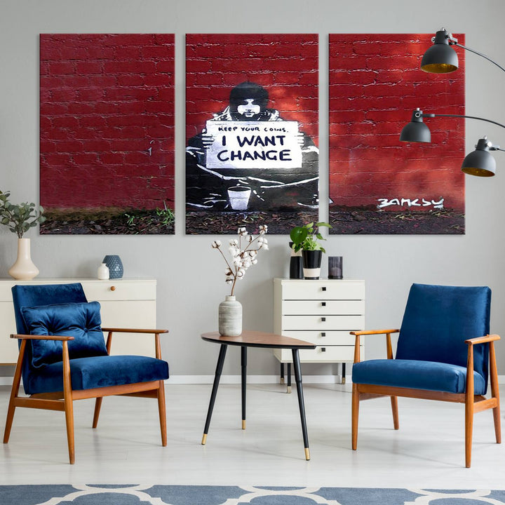 The living room showcases a triptych of stencil artwork on museum-quality canvas, featuring the Banksy I Want Change Graffiti Abstract Wall Art Canvas Print. This captivating piece depicts a person holding a sign that says "I want change" and is finished with a UV-protective coating to ensure long-lasting beauty.