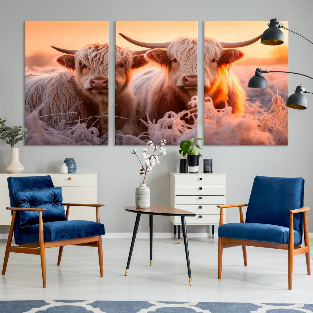 The "Highland Cows at Sunrise Wall Art Canvas Set" beautifully captures a serene and rustic farmhouse aesthetic, portraying two Highland cows in a frosty landscape at sunrise.