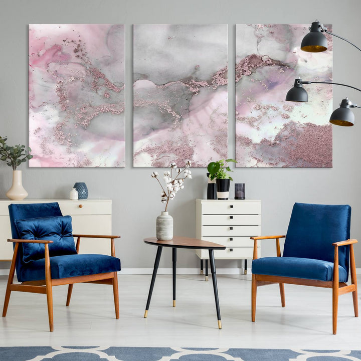 The Rose Marble Abstract Wall Art Canvas Print is a stunning triptych that showcases pink and gray tones, elegantly presented on a dark wall.