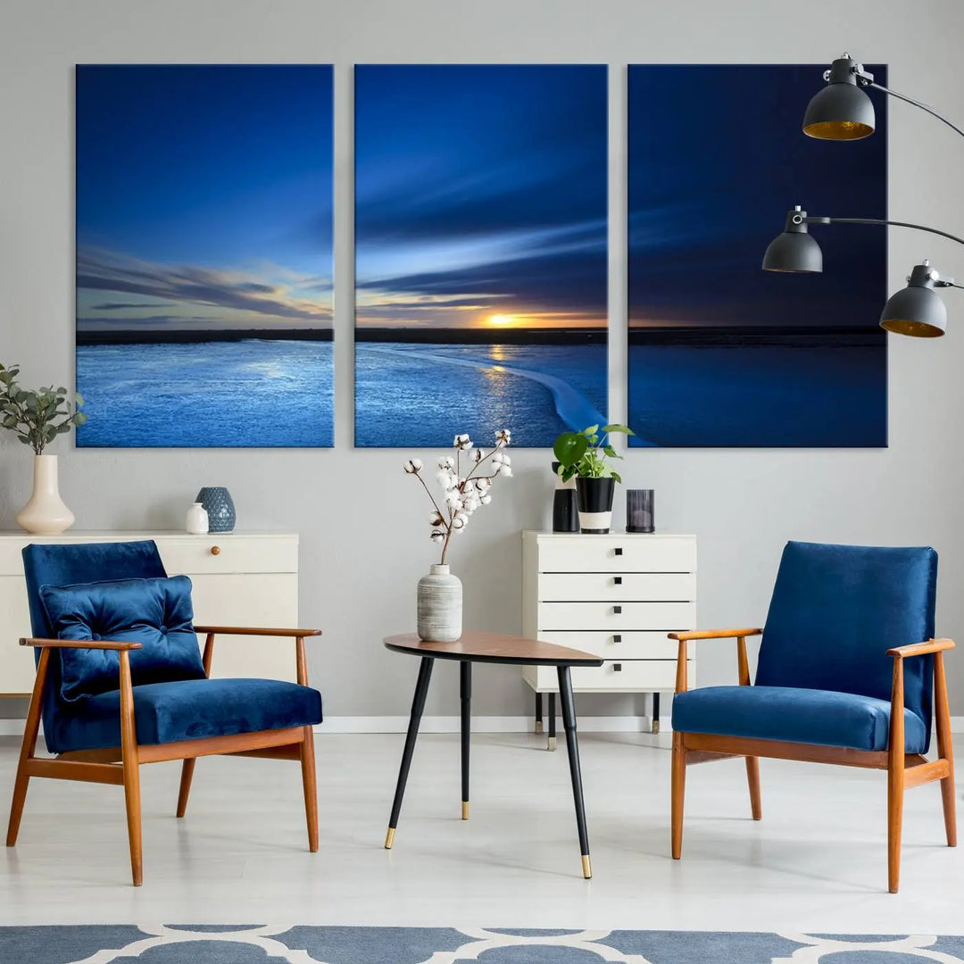 The living room features a triptych of the Wall Art Canvas Print Navy Sunset Lake Landscape Artwork, adding to its tranquil vibe.