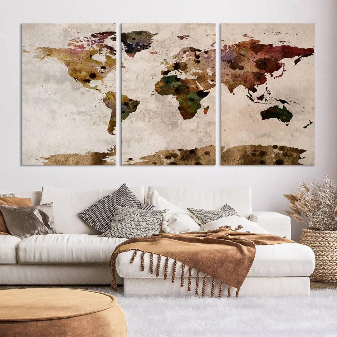 A Watercolor World Map Canvas Print, wrapped in an elegant gallery style, hangs on the wall.