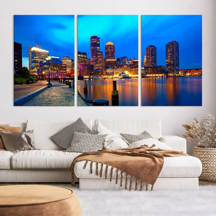 A triptych of the "Boston City Lights Night Blue Skyline Cityscape View Wall Art Canvas Print" adorns the wall. This museum-quality canvas artwork is ready to hang and includes a UV-protective coating for lasting brilliance.