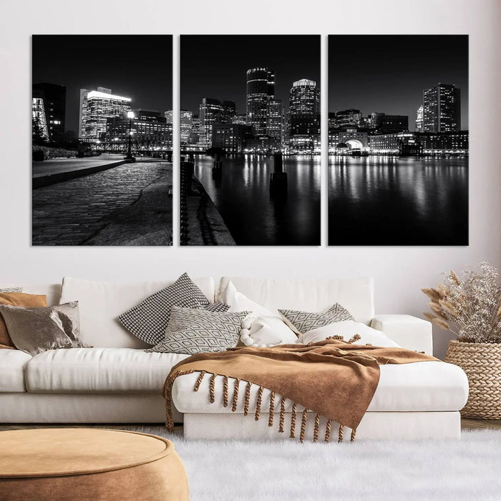 The Boston City Lights Skyline Black and White Wall Art Cityscape Canvas Print portrays a triptych of the city skyline at night reflecting on a calm river. This museum-quality canvas features UV-protective finishes to preserve its timeless allure.