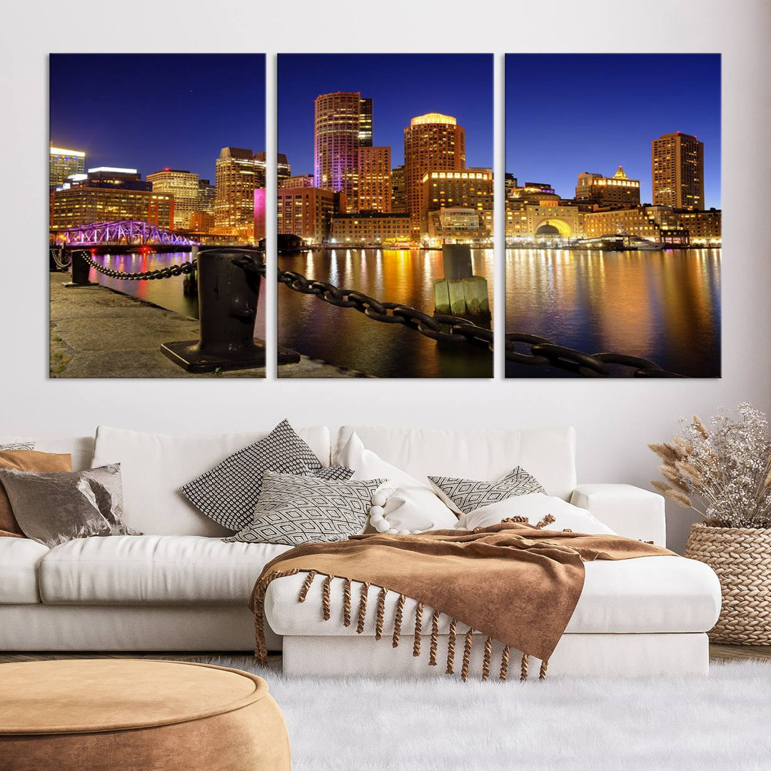 The "Boston City Night Skyline Cityscape View Wall Art Canvas Print" beautifully portrays a stunning triptych of a city skyline illuminated against the night sky, elegantly reflected in the river below. These museum-quality canvases are gallery wrapped to ensure an elegant presentation that enhances any space.