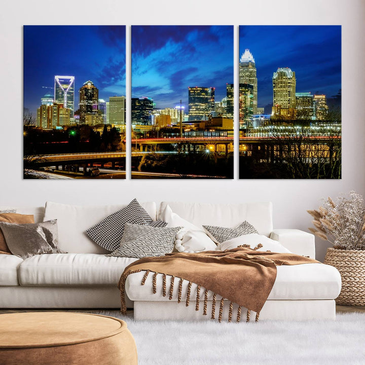 A modern living room highlighted by the "Charlotte City Lights Cloudy Blue Night Skyline Cityscape View" wall art canvas print, crafted on museum-quality canvas with UV-protective coating.