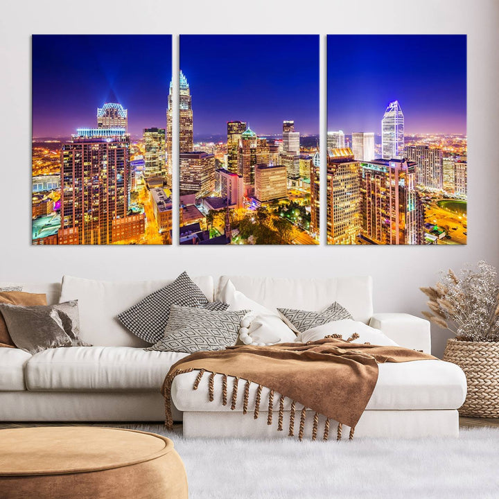 A modern living room features the Charlotte City Lights Night Blue Skyline Cityscape View wall art canvas print.