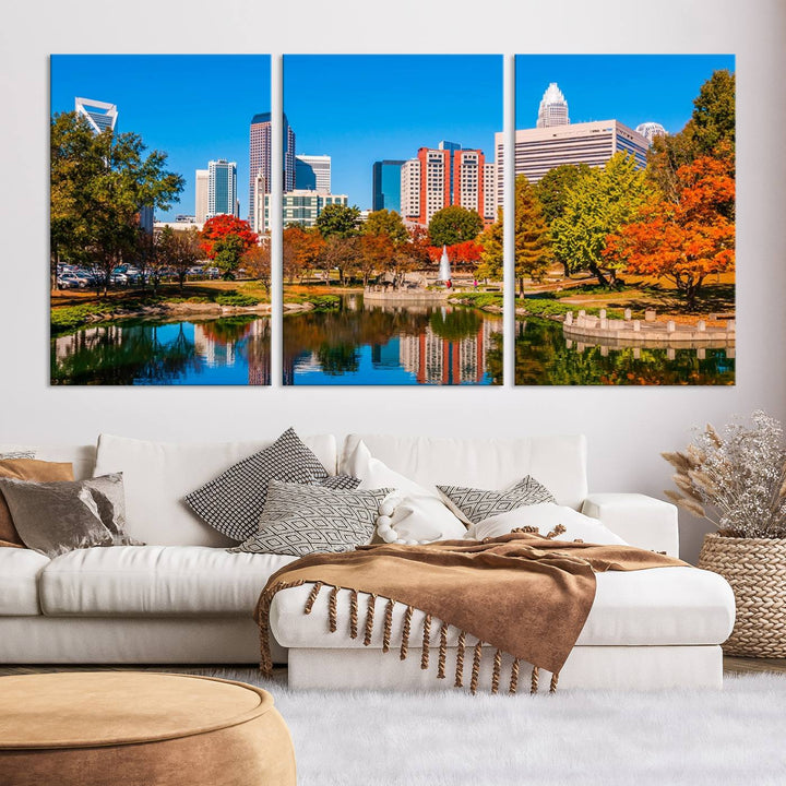 The Charlotte City Park at Fall Skyline Cityscape View wall art canvas print features a city panorama with a park and lake accented by autumn trees. It is mounted on museum-quality canvas with UV-protective coating and decorates the space.