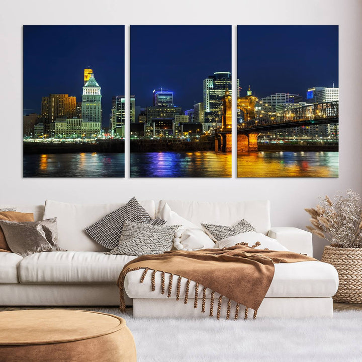 The "Cincinnati City Lights Night Skyline Cityscape" canvas print, displayed above a sofa, exhibits museum-quality craftsmanship with a UV-protective coating.