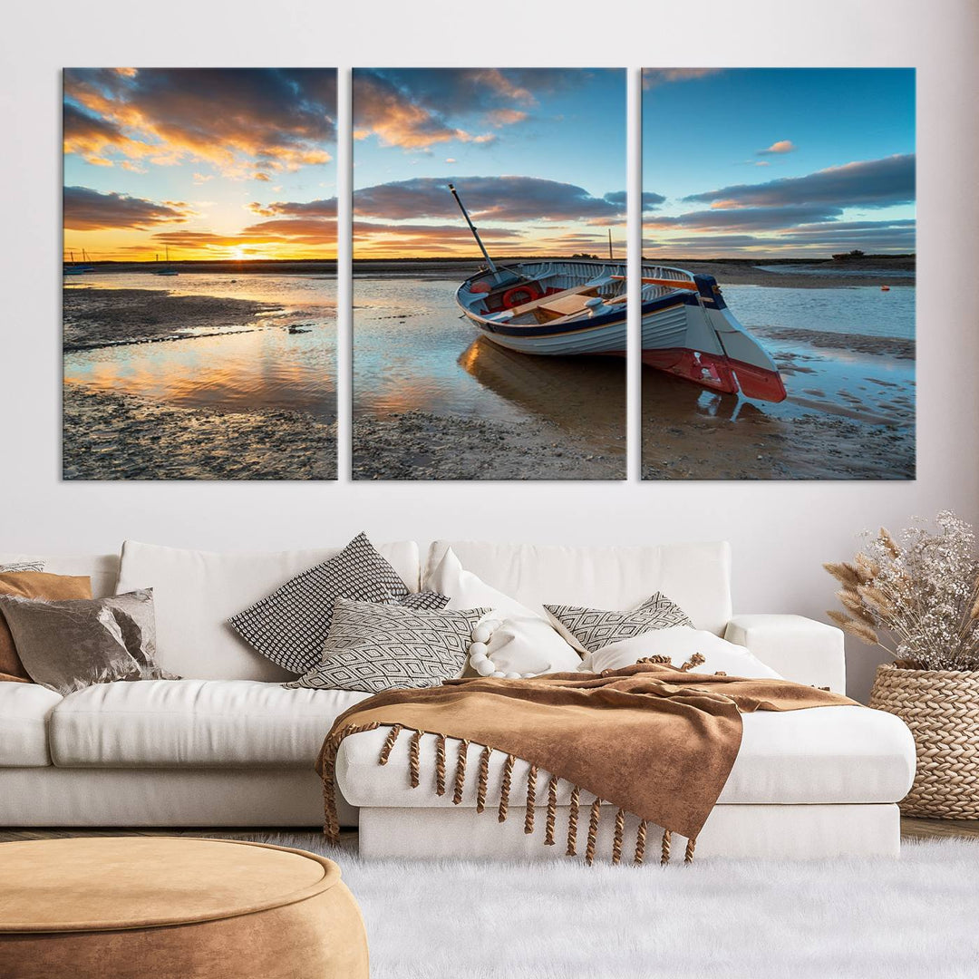 The "Small Boat At The Beach Sunset Wall Art Canvas Print," a three-panel masterpiece crafted on museum-quality canvas, hangs elegantly.