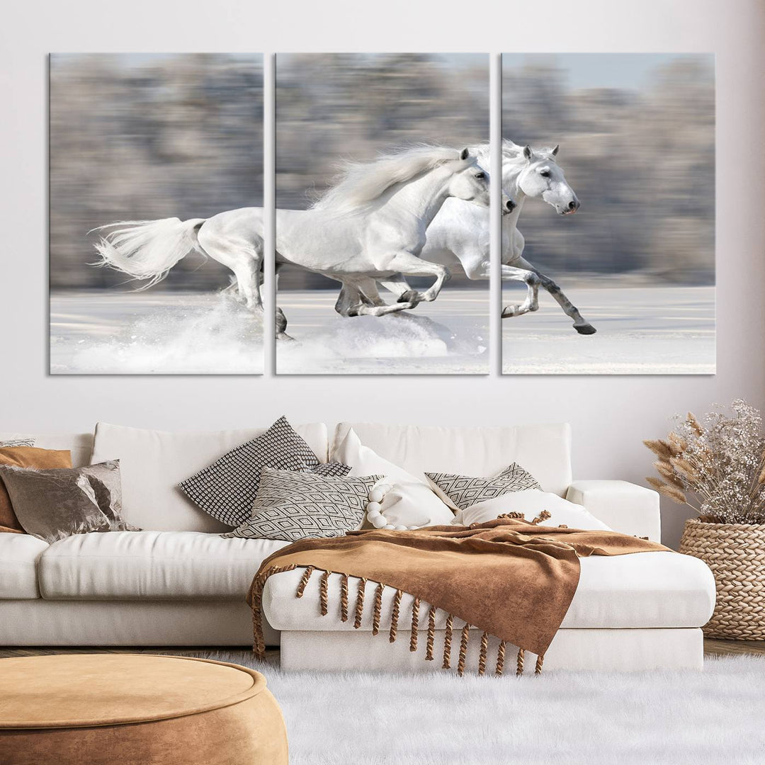 The "All The White Horses Wall Art Canvas Print" depicts a triptych of galloping white horses across a snowy landscape. These museum-quality canvases come with a UV-protective coating to maintain their stunning appearance over time.