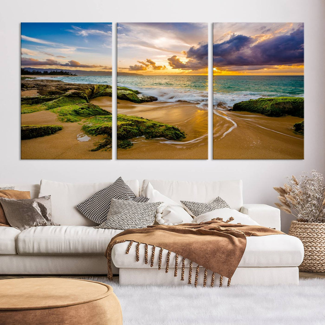 The Sunset Beach Wall Art Canvas Print is a gallery-wrapped triptych showcasing a beach scene with mossy rocks and a vibrant sunset. Made from museum-quality canvas and featuring a UV-protective coating, it elegantly provides both beauty and durability.