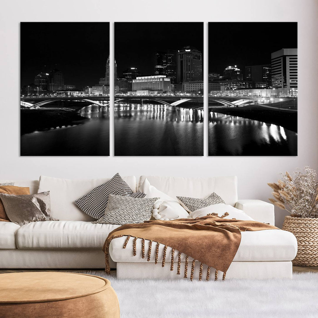 The living room features the "Columbus City Lights Skyline Black and White Wall Art Cityscape Canvas Print" above a coffee table. This artwork is presented as a triptych on museum-quality canvases with UV-protective coating.