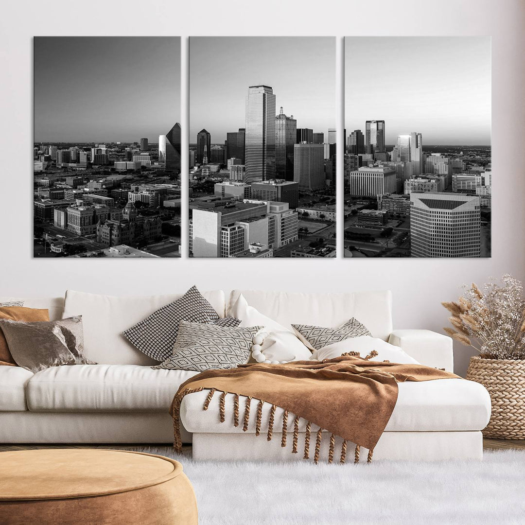 A modern living room showcases the Dallas City Lights Skyline Black and White Wall Art Cityscape Canvas Print. This gallery-wrapped piece offers a sleek finish and is crafted from museum-quality pollycotton. It features a UV-protective coating to ensure lasting vibrancy.