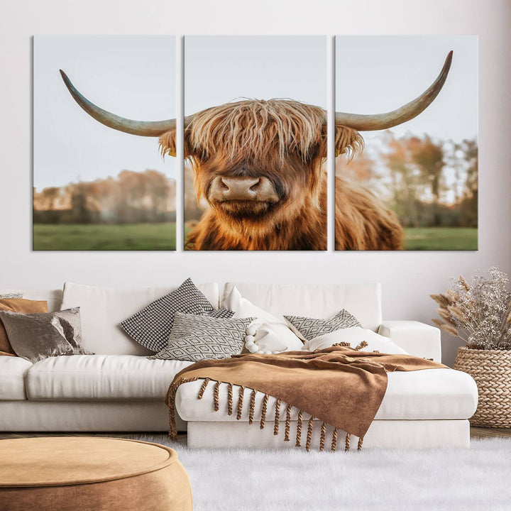 A Highland Cow Animal Scottish Cattle Art Print Farmhouse Wall Art Canvas Print hangs in the living room, adding a touch of rustic farmhouse decor.