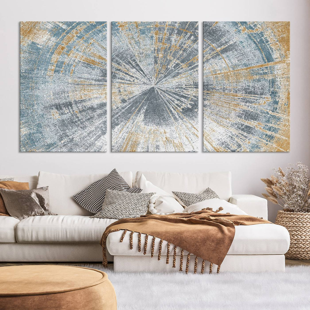 The Radiant Abstract Wood Rings Canvas Art, a modern triptych wall decor, enhances the contemporary style of the living room with its blue, white, and gold hues.