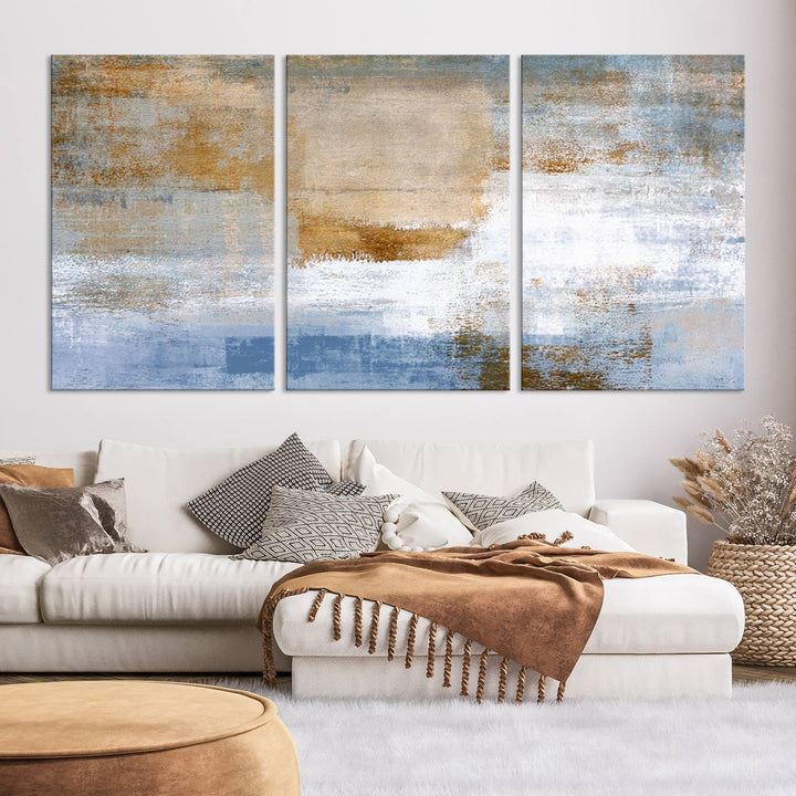 The Blue Multi Panel Abstract Wall Art Canvas Print, featuring an elegant blend of blue, beige, and brown tones, hangs gracefully on the wall, adding a contemporary touch to the space.