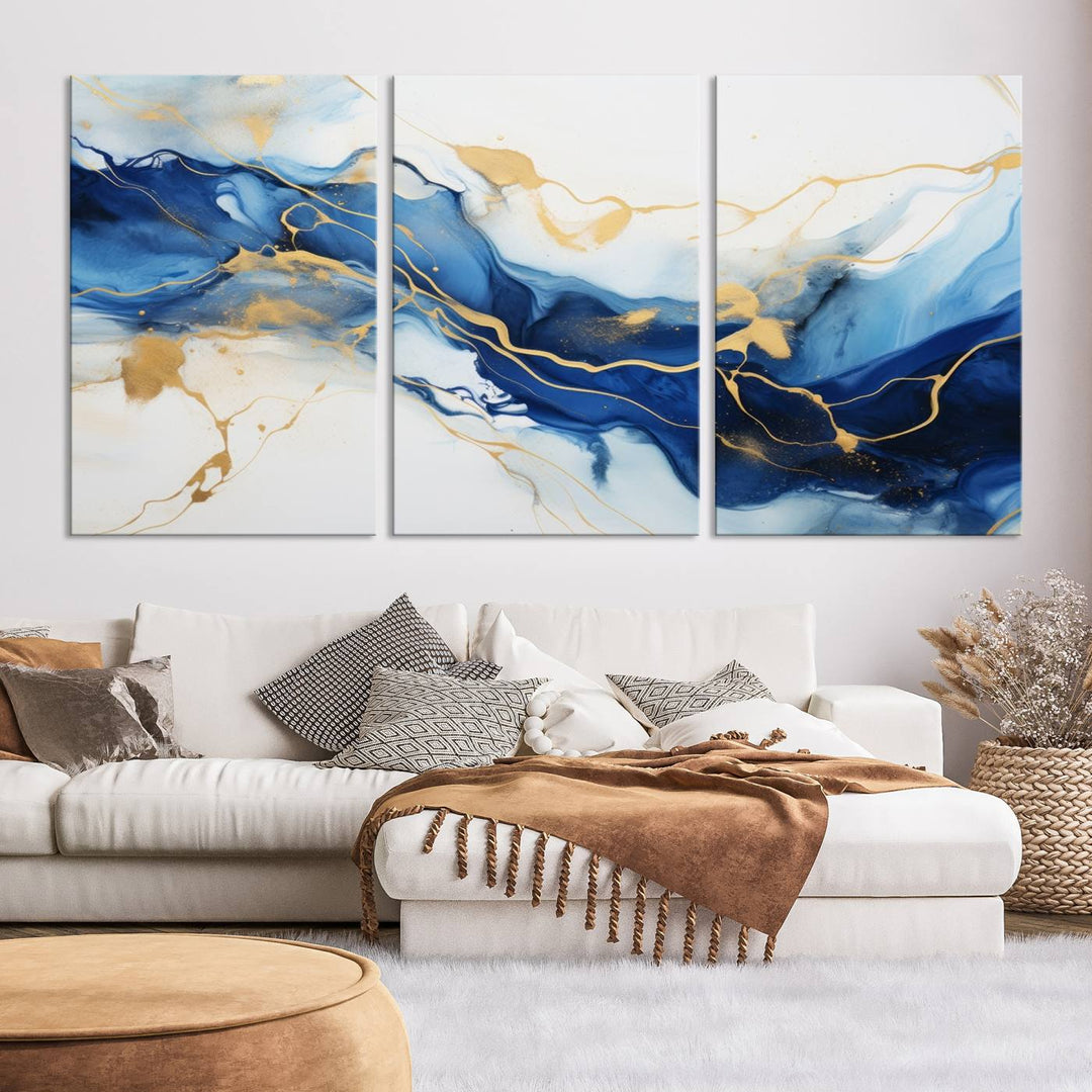 The Blue Abstract Wall Art is displayed as a triptych on museum-quality canvas, showcasing a blue and gold abstract design. The artwork includes a UV-protective coating to maintain its vibrancy and comes with the benefit of free shipping.