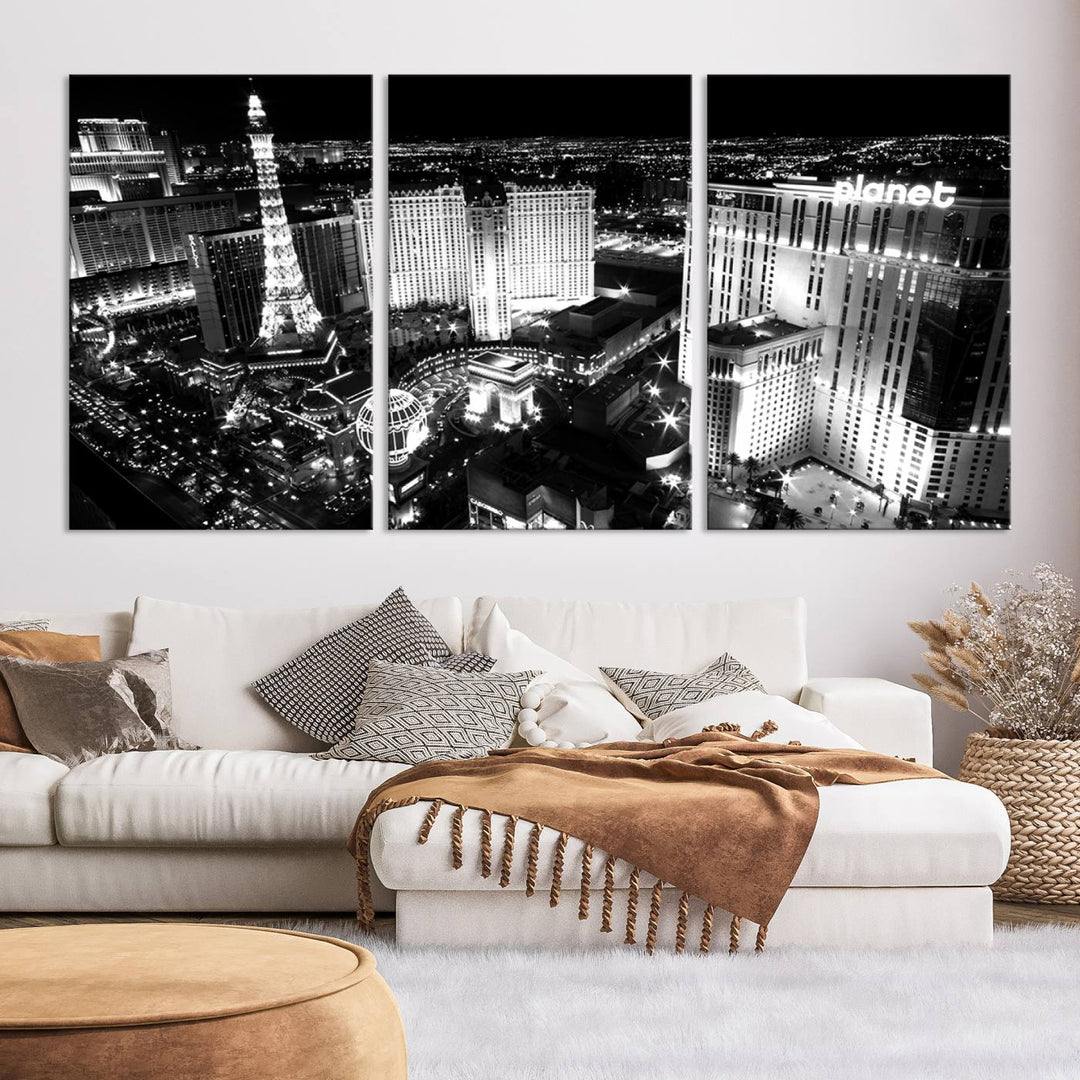 The Las Vegas Wall Art Canvas Print is a black and white triptych that showcases a city skyline at night. Crafted on museum-quality canvas with a UV-protective coating, it serves as an elegant and ready-to-hang focal point in the room.