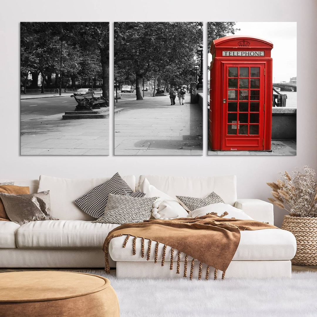 The London Phone Club Wall Art is a stunning piece that showcases a red telephone box set in a black and white street scene on museum-quality canvas. It is gallery wrapped with a UV-protective coating to preserve its vibrant charm.