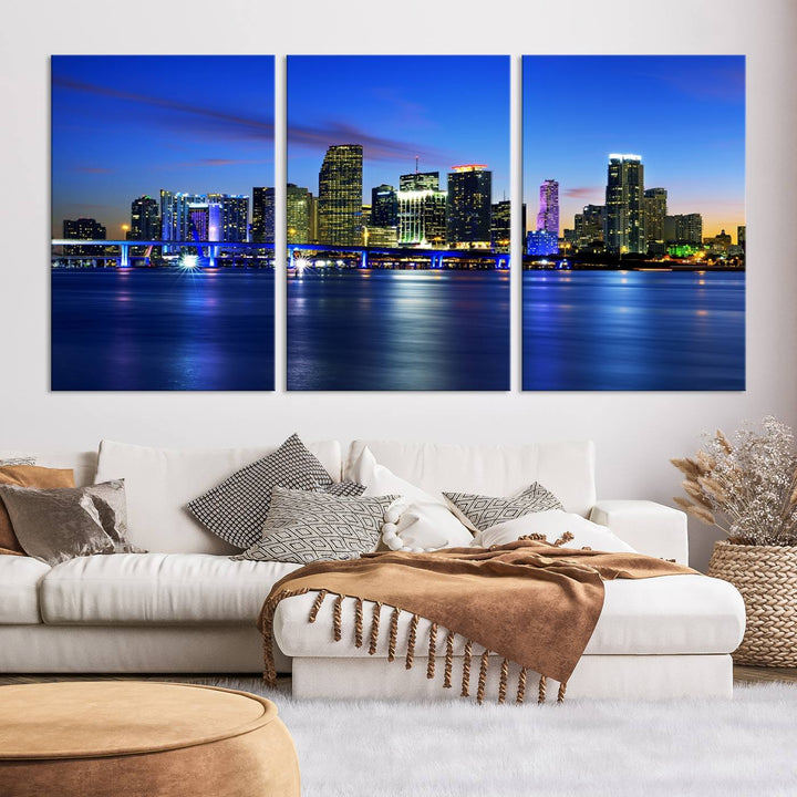 The modern living room showcases a striking Miami Blue Night Wall Art canvas print on the wall. The artwork is gallery wrapped on museum-quality canvas, ensuring durability and elegance.