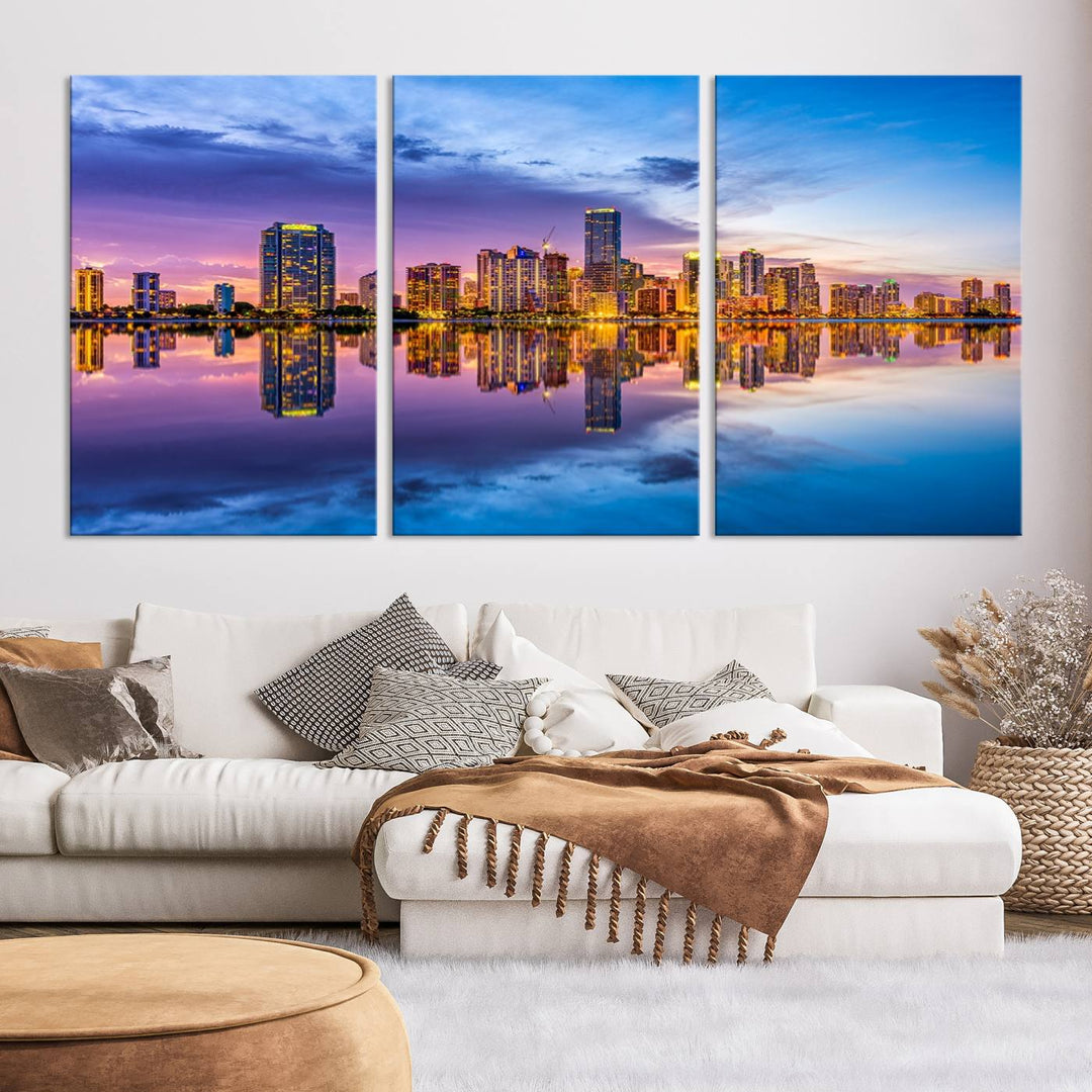 The Miami City Wall Art Canvas Print, featuring a three-panel depiction of a city skyline at sunset reflected in water, beautifully enhances the wall. Made with museum-quality canvas and a UV-protective coating, it comes ready to hang.