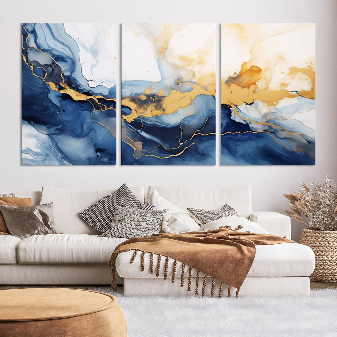 A contemporary living room featuring the "Navy Blue Gold Abstract Wall Art Canvas Print" on the wall, displayed on a gallery-wrapped, museum-quality canvas.