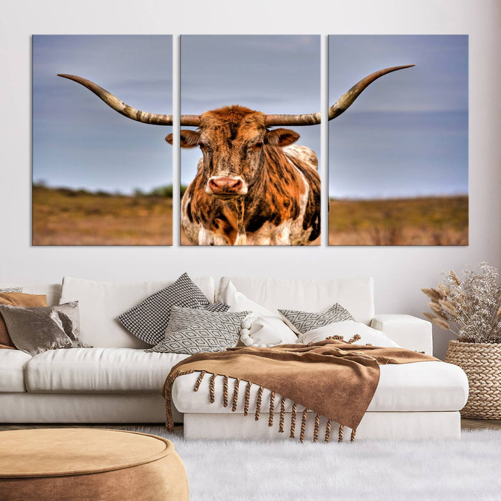 The Texas Longhorn Wall Art Print, a triptych canvas artwork depicting a longhorn bull in a field, features a gallery-quality finish.