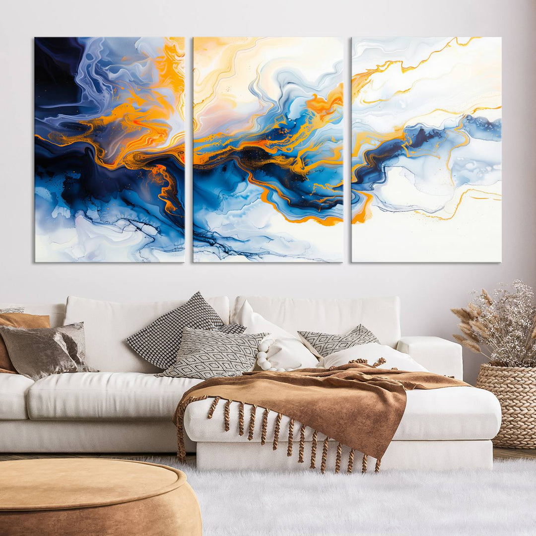 A stunning Fluid Alcohol Ink Wall Art with Gold Wall Art Canvas Print, featuring vibrant blue, orange, and white swirls, adorns the wall. This gallery-quality finish adds an exquisite touch to any living space.