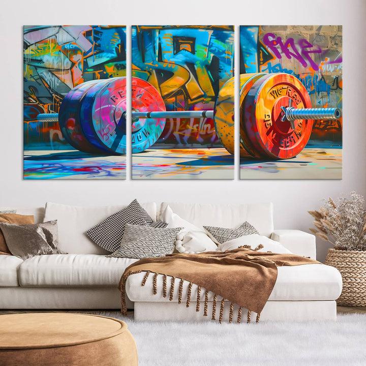 The Fitness Gym Barbell Graffiti Wall Art Canvas Print, a vibrant triptych featuring a barbell against a graffiti backdrop, elegantly hangs in the room. Crafted on premium canvas with a gallery-quality finish, this stunning piece of wall art effortlessly combines urban flair with sophisticated decor.