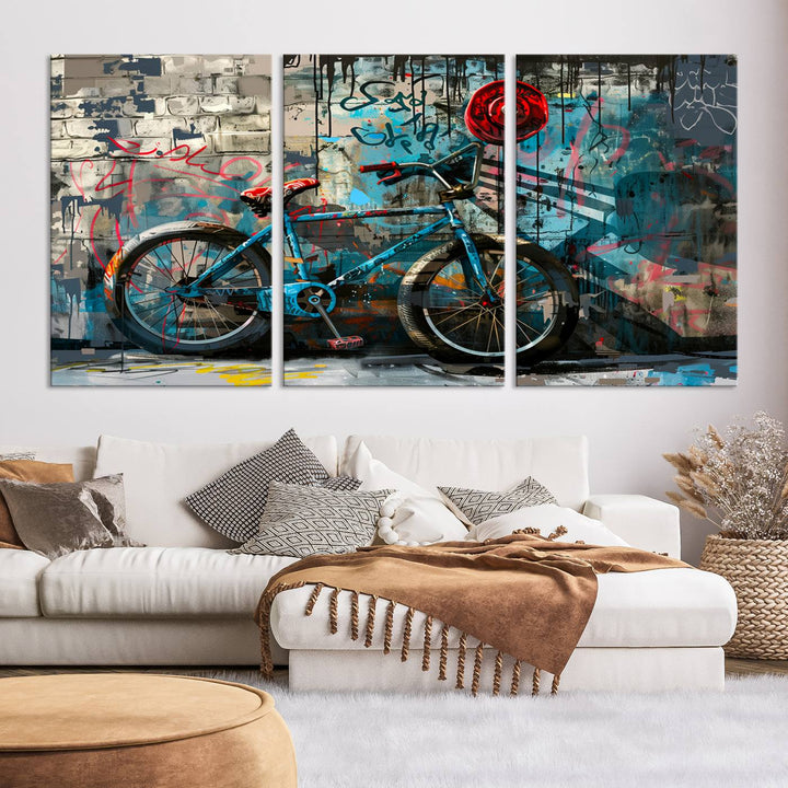 A modern living room features a triptych wall art of an abstract bicycle, designed in a graffiti style on a brick wall. This piece is expertly crafted on the Abstract Bicycle Wall Art Canvas Print, offering a premium canvas that ensures a gallery-quality finish.