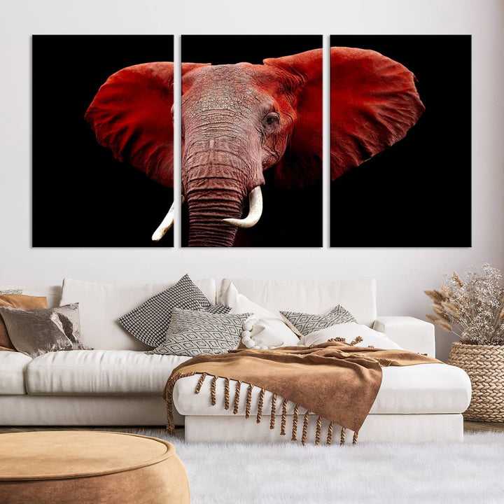 A Wall Art Canvas Print in the modern living room features a three-panel premium design of a red elephant face.