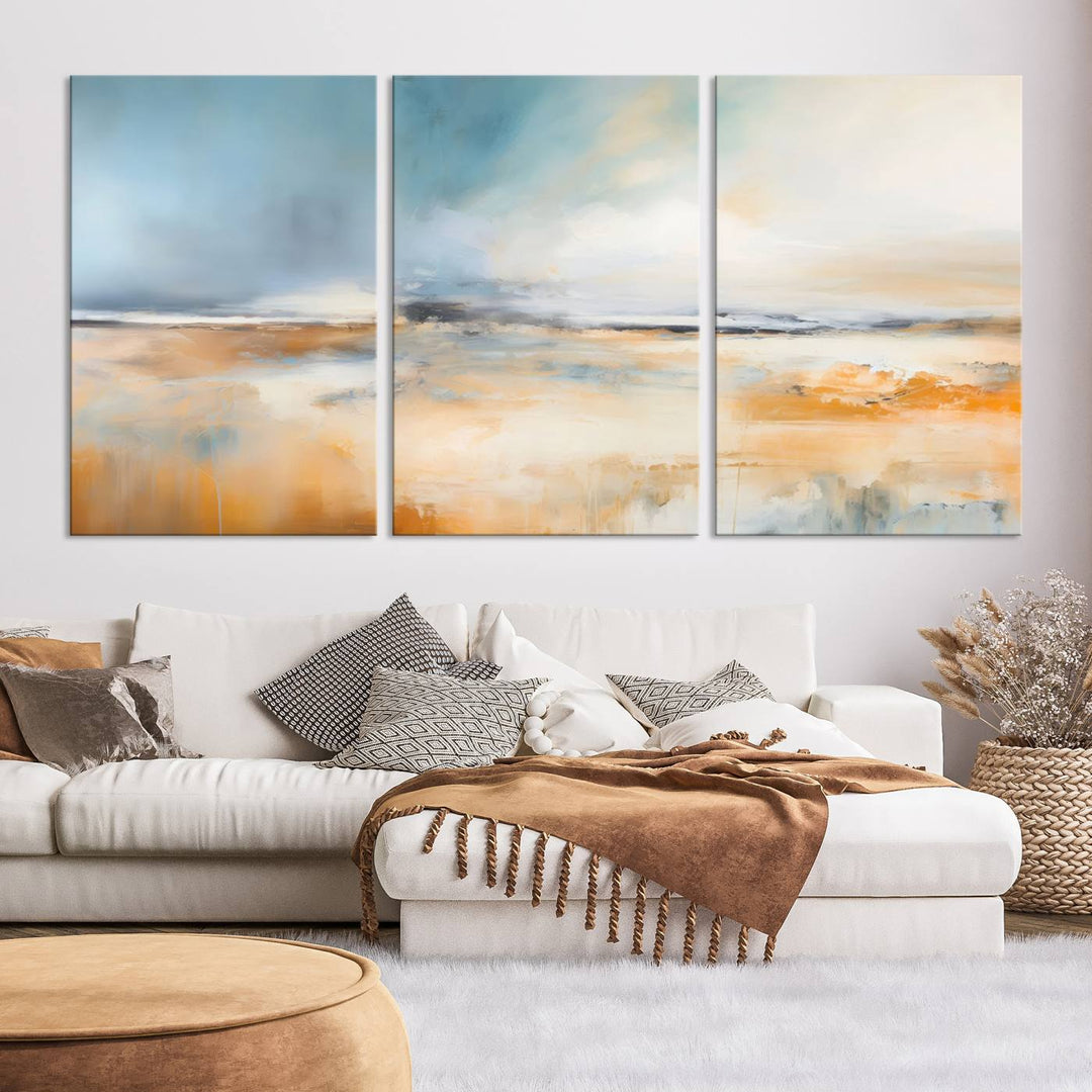 The Abstract Landscape Wall Art Canvas Print, featuring warm tones of orange and blue, is displayed on a dark wall.