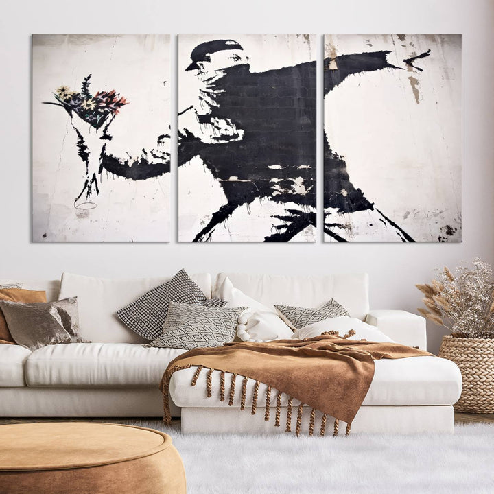 The living room features a split-panel art piece named "Banksy Flower Throw Graffiti Street Wall Art Canvas Print," gallery wrapped on museum-quality polycotton canvas and accentuated by modern decor elements.