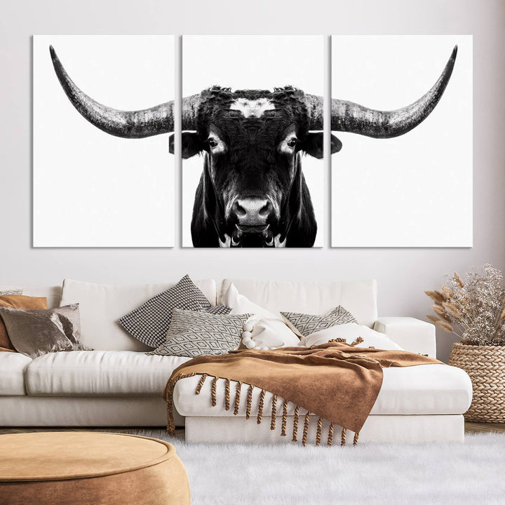 The living room is adorned with the Texas Cow Longhorn Wall Art Canvas Print in Black and White—framed and ready to hang.