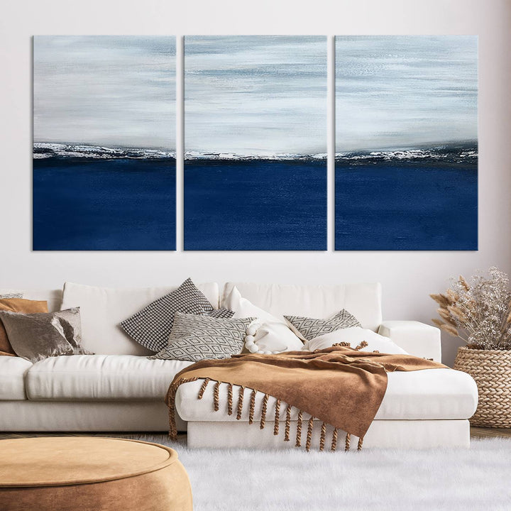 The modern living room is enhanced by the Navy Blue Abstract Wall Art Canvas Print on the wall, crafted as handmade wall art with a gallery-quality finish.