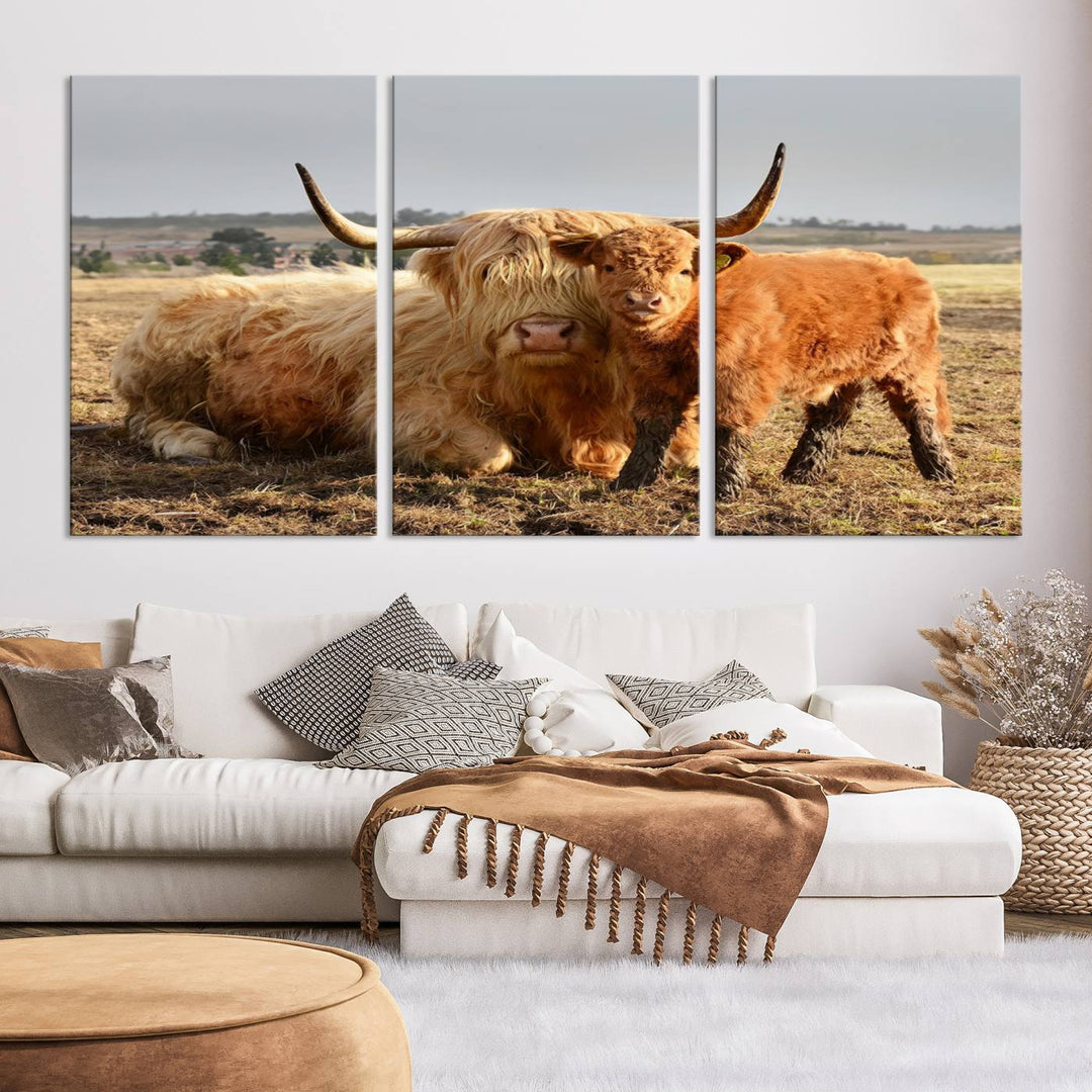 The three-panel canvas artwork, titled "Highland Cow Canvas Wall Art Animal Print for Farm House Decor," features a serene scene of a resting Highland cow and calf in a field. The piece highlights its gallery-quality finish.