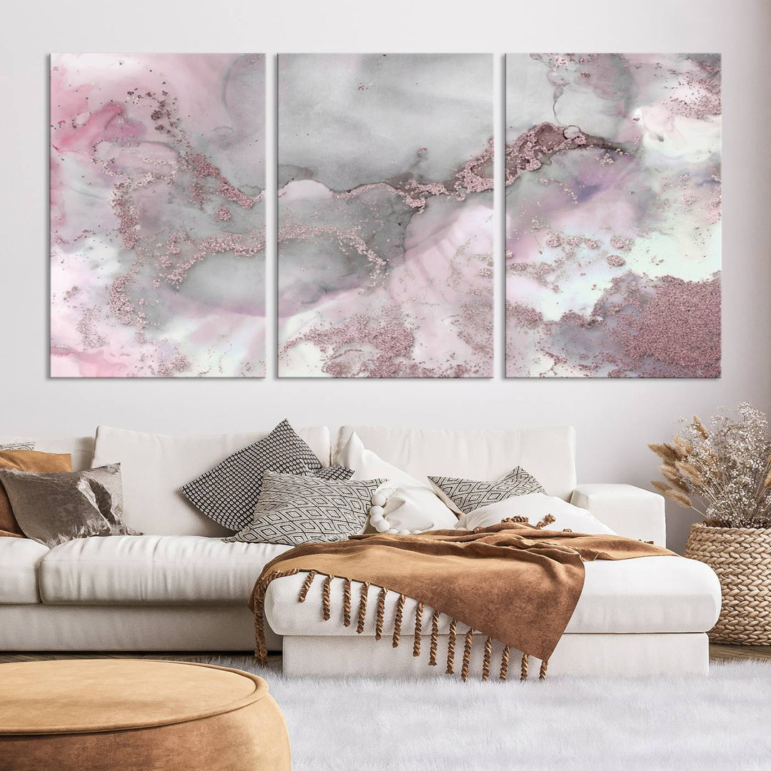 The Rose Marble Abstract Wall Art Canvas Print is a stunning triptych that showcases pink and gray tones, elegantly presented on a dark wall.