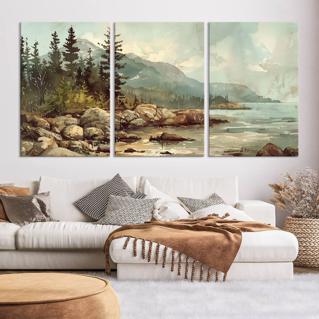 The living room features a breathtaking three-panel Abstract Acadia National Park Wall Art Canvas Print, which beautifully captures the rocky Maine coastline with trees and mountains.