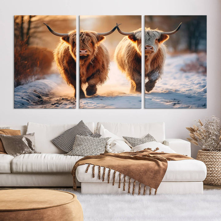 The living room showcases a triptych from the Scottish Highland Cow Horn Farm Wall Art Canvas Print collection, depicting two Highland cows running in the snow. Complementing this are handmade wall art pieces with a gallery-quality finish that add an elegant touch.