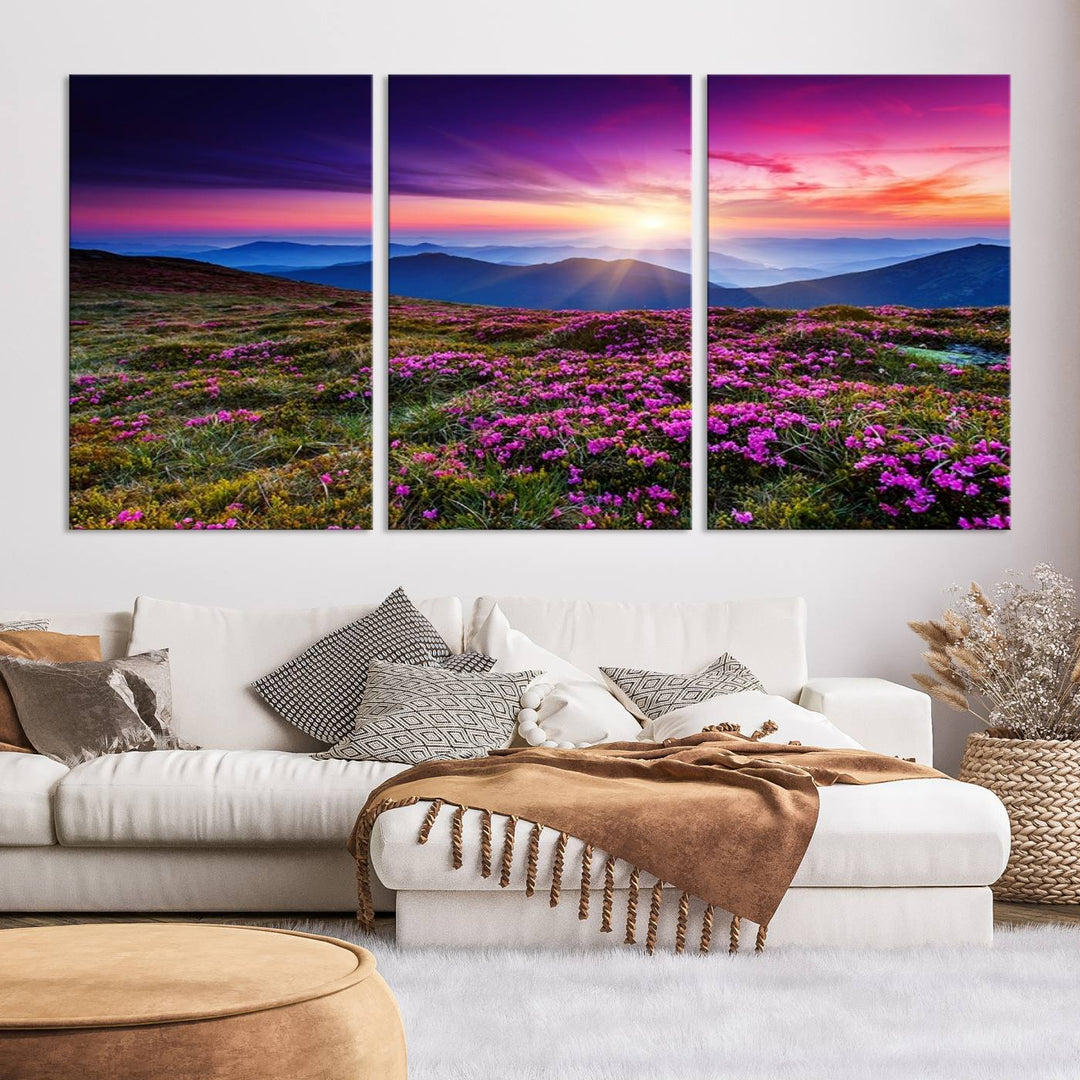 Vibrant sunset over mountain meadows with purple wildflowers in a 3-panel landscape canvas print. Perfect for living rooms and offices.