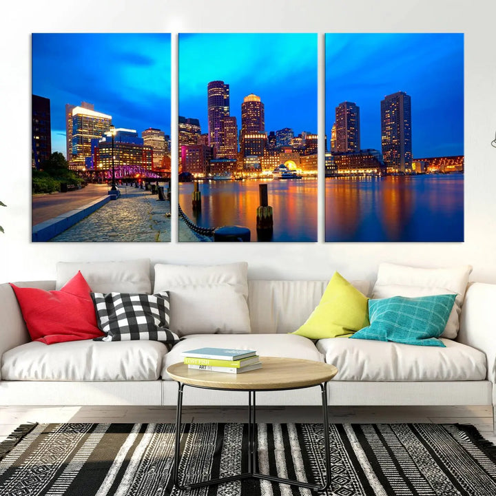 A triptych of the "Boston City Lights Night Blue Skyline Cityscape View Wall Art Canvas Print" adorns the wall. This museum-quality canvas artwork is ready to hang and includes a UV-protective coating for lasting brilliance.