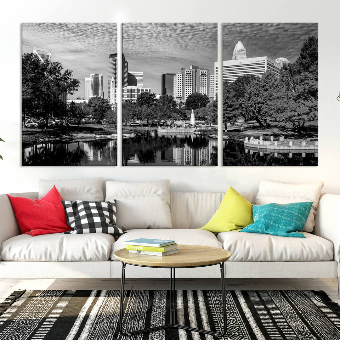 The living room features a captivating triptych titled "Charlotte City Cloudy Skyline Black and White Wall Art Cityscape Canvas Print," crafted on museum-quality canvas with UV-protective coating. Modern decor accentuates the dynamic scene.