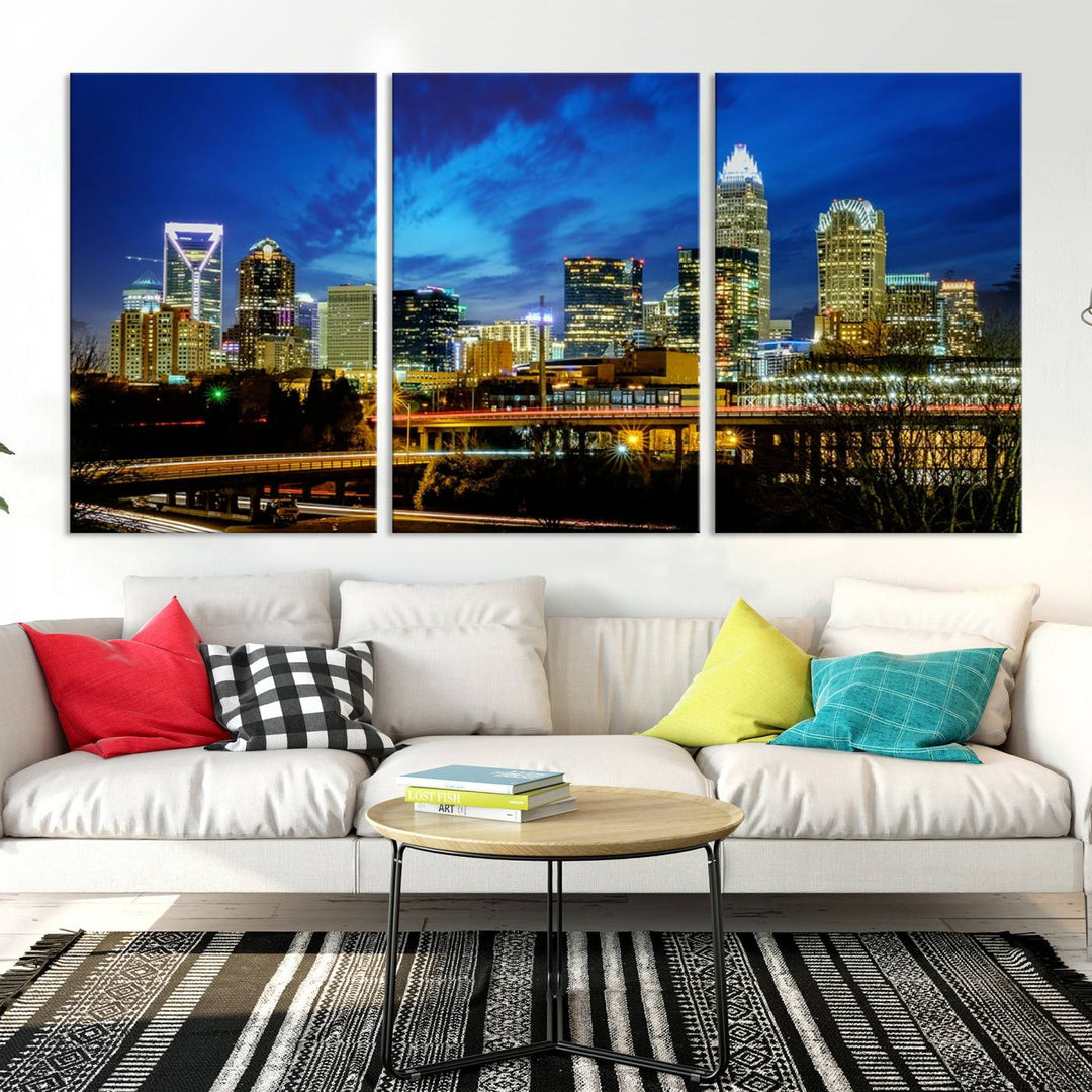 A modern living room highlighted by the "Charlotte City Lights Cloudy Blue Night Skyline Cityscape View" wall art canvas print, crafted on museum-quality canvas with UV-protective coating.