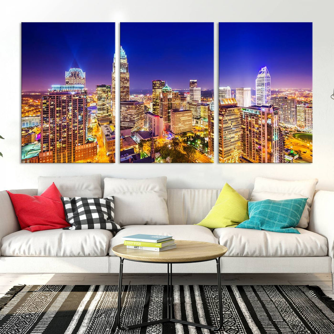 A modern living room features the Charlotte City Lights Night Blue Skyline Cityscape View wall art canvas print.