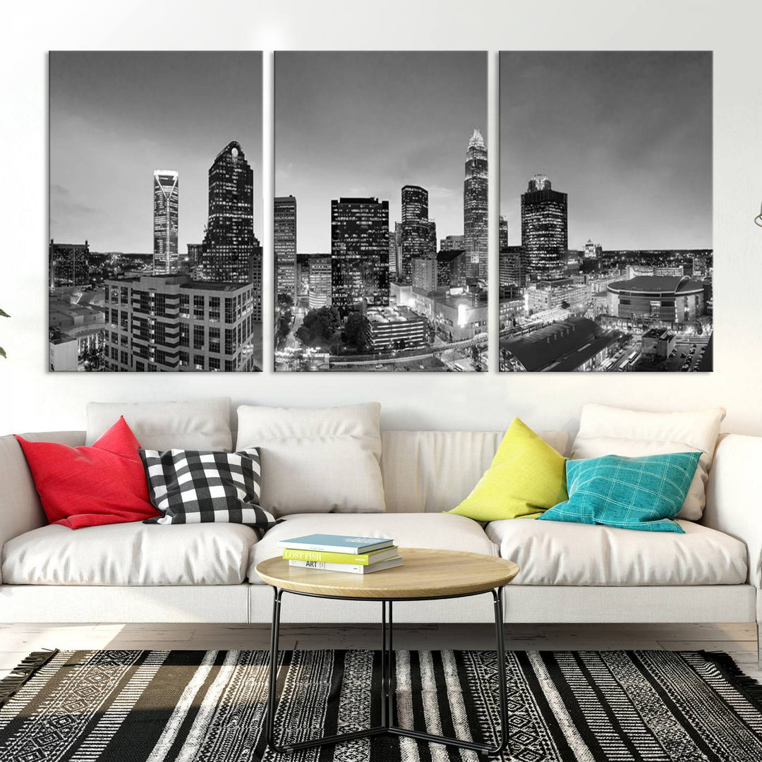 The "Charlotte City Cloudy Skyline Black and White Wall Art Cityscape Canvas Print" hangs on a dark wall, showcasing its UV-protective properties for enduring beauty.