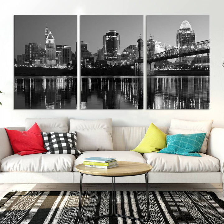 The wall showcases a ready-to-hang triptych of the Cincinnati City Lights Skyline in black and white, printed on museum-quality canvas.