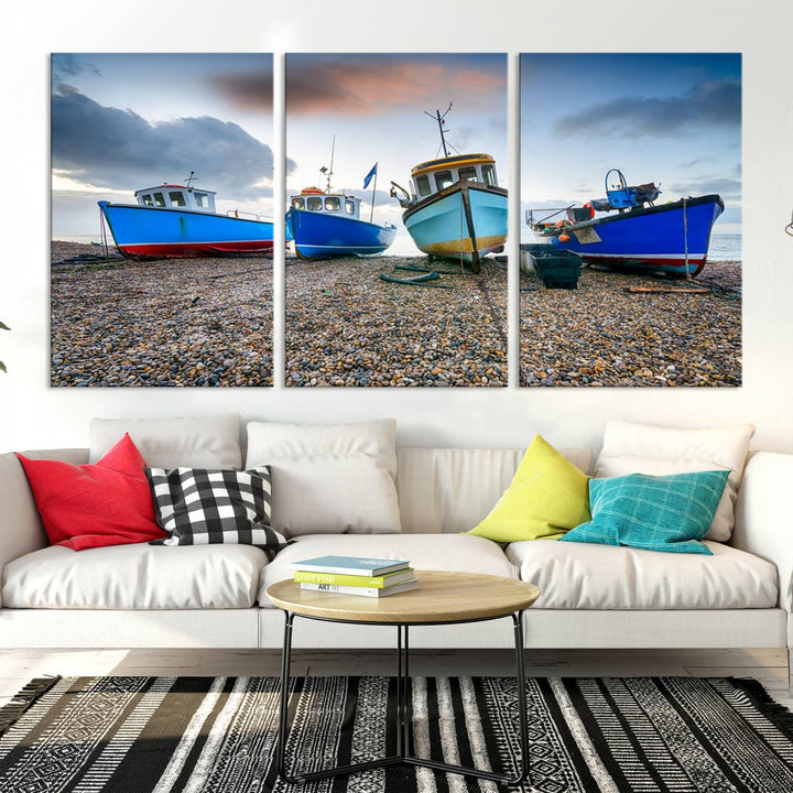 The "Big Boats On The Beach Wall Art Canvas Print" is a stunning piece featuring three museum-quality panels depicting fishing boats on a pebbled shore. Ready to hang and featuring UV-protective coating, it serves as an elegant addition to your home décor.