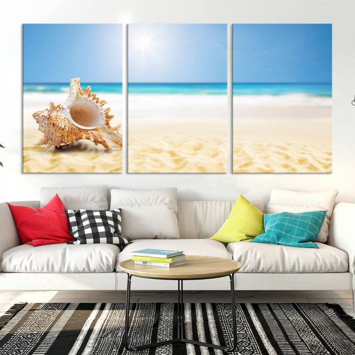 The Sea Shell on The Beach Sun Sand Wall Art Canvas Print is a triptych that beautifully captures a beach scene with a large seashell on the sand.