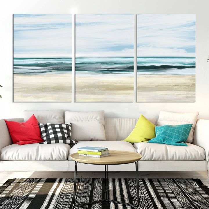 The room features the Ocean Abstract Wall Art Canvas Print, a triptych beach painting on museum-quality canvas with a gallery-wrapped finish and UV-protective coating.