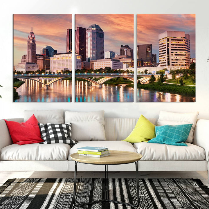 The "Columbus City Lights Sunset Orange Cloudy Skyline Cityscape View" wall art is featured on the wall. This triptych is printed on museum-quality canvas and includes a UV-protective coating, ensuring lasting vibrancy.